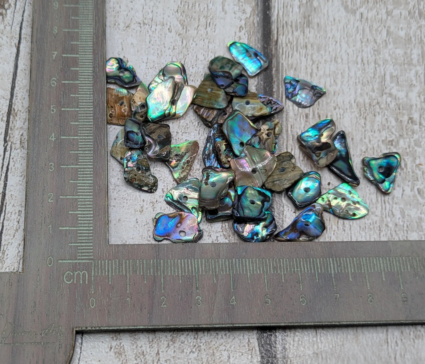 20 New Zealand rainbow pāua abalone shell central tiny beads.