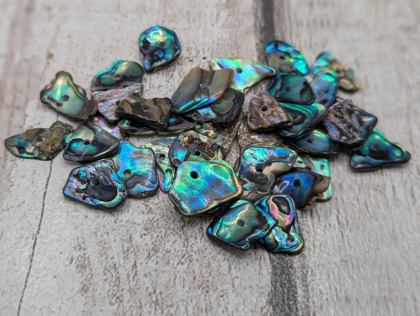 20 New Zealand rainbow pāua abalone shell central tiny beads.
