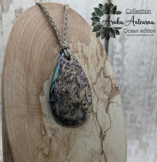 Carved NZ Pāua Shell Oval Pendant – Handcrafted Rainbow Abalone Jewel, Ocean-Inspired fashion, iridescent amulet.