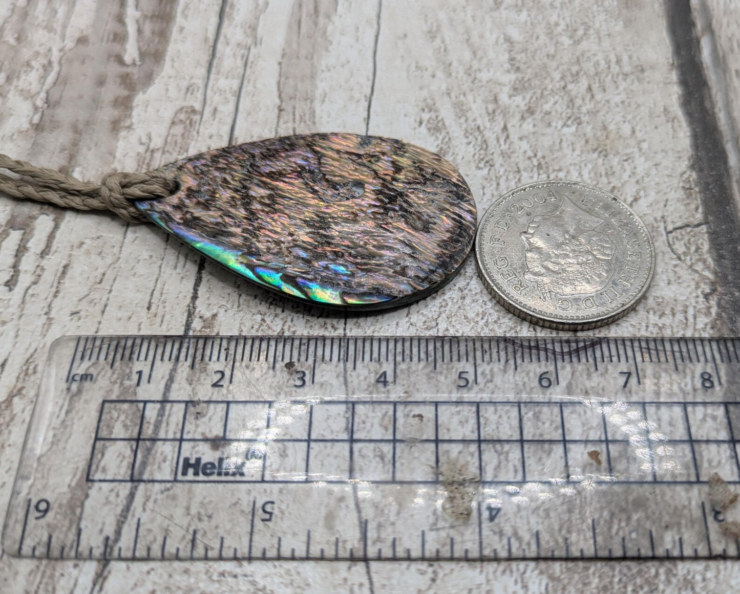 Carved NZ Pāua Shell Oval Pendant – Handcrafted Rainbow Abalone Jewel, Ocean-Inspired fashion, iridescent amulet.