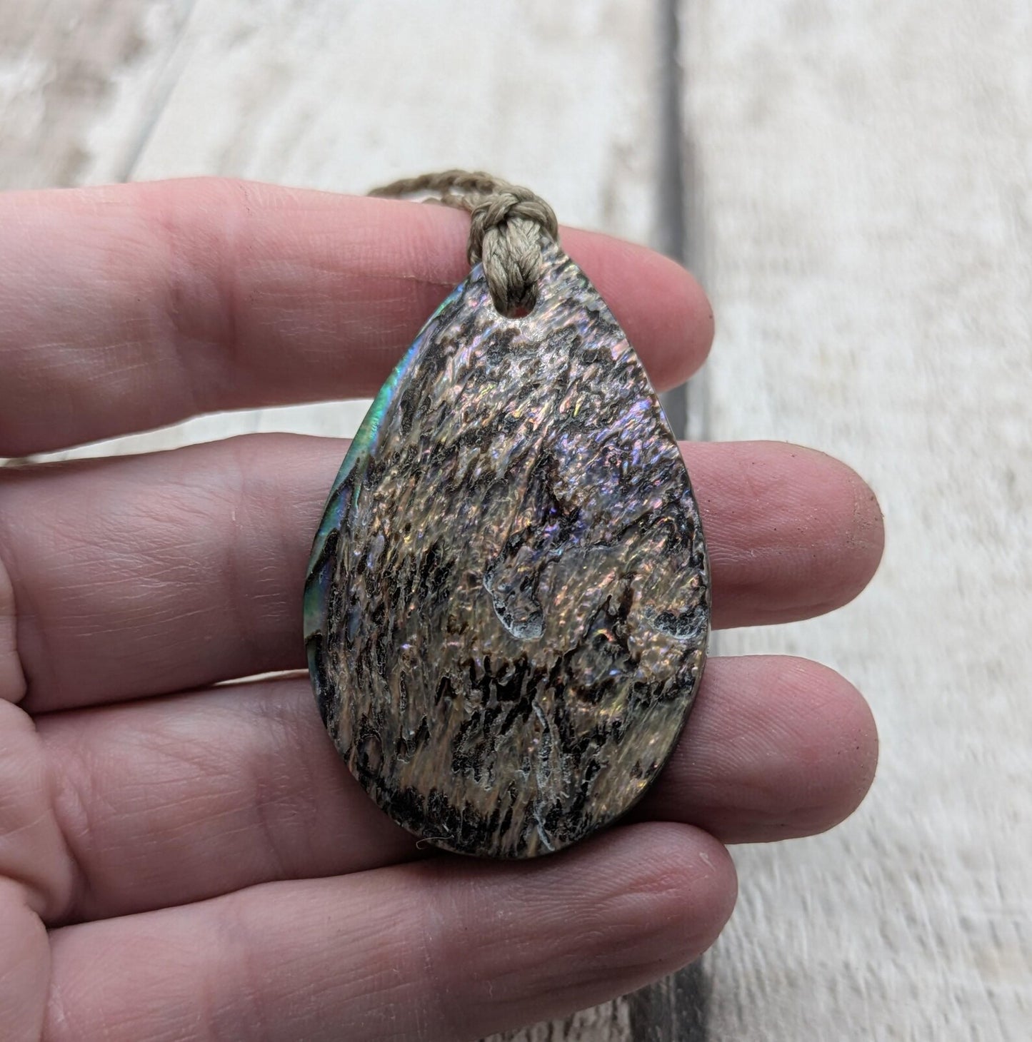 Carved NZ Pāua Shell Oval Pendant – Handcrafted Rainbow Abalone Jewel, Ocean-Inspired fashion, iridescent amulet.