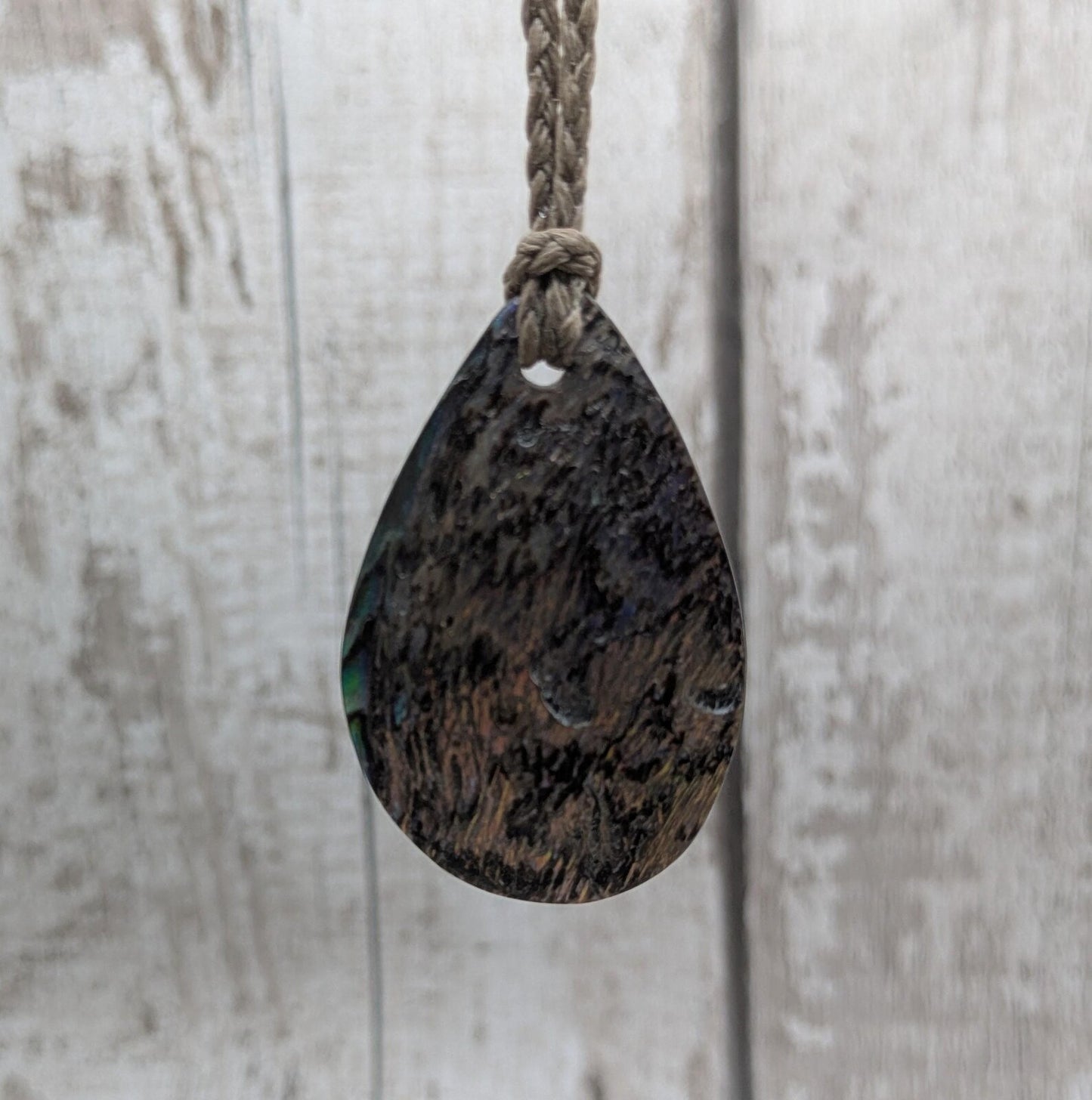 Carved NZ Pāua Shell Oval Pendant – Handcrafted Rainbow Abalone Jewel, Ocean-Inspired fashion, iridescent amulet.
