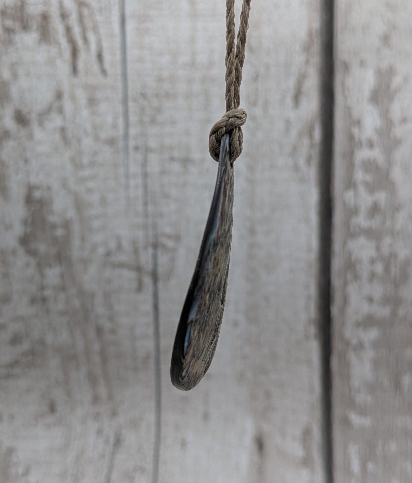 Carved NZ Pāua Shell Oval Pendant – Handcrafted Rainbow Abalone Jewel, Ocean-Inspired fashion, iridescent amulet.