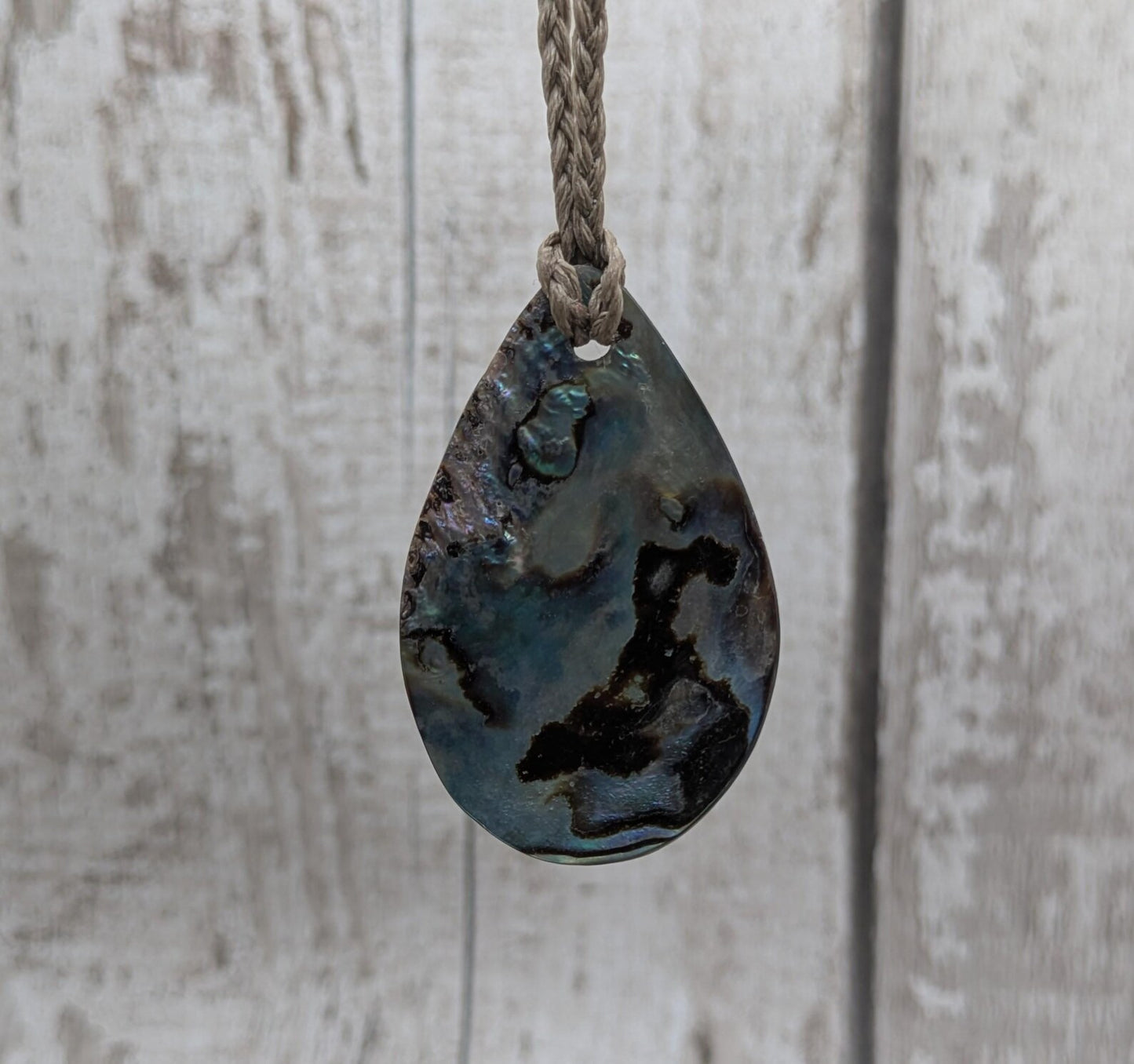 Carved NZ Pāua Shell Oval Pendant – Handcrafted Rainbow Abalone Jewel, Ocean-Inspired fashion, iridescent amulet.