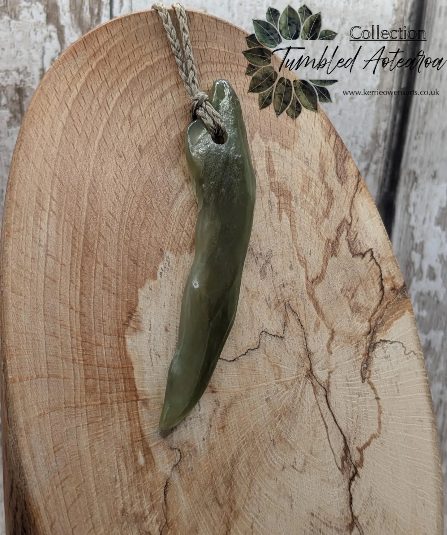 Tumbled nephrite jade Pounamu stone pendant.