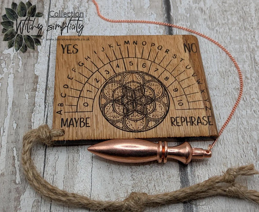 Oak wood travel sized pendulum board with geometric design.