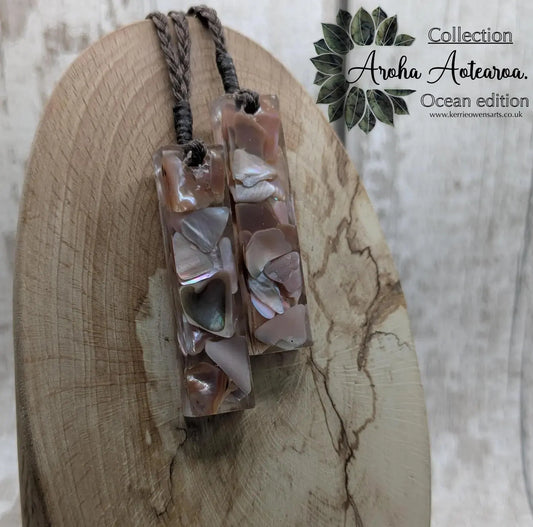 One New Zealand fresh water pink mussel shell in resin.
