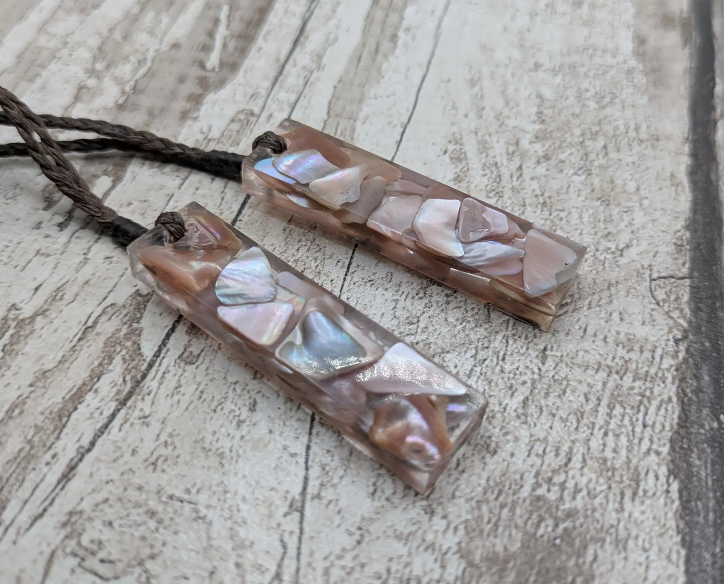 One New Zealand fresh water pink mussel shell in resin.