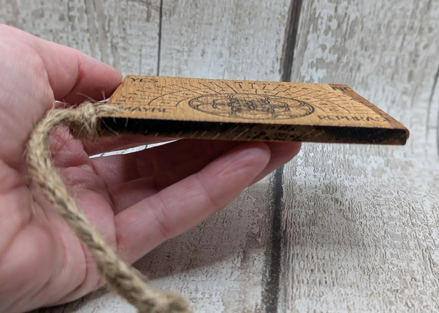Oak wood travel sized pendulum board with geometric design.