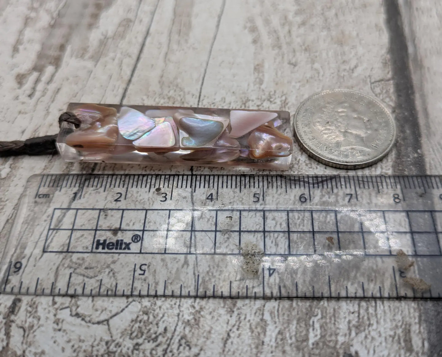 One New Zealand fresh water pink mussel shell in resin.