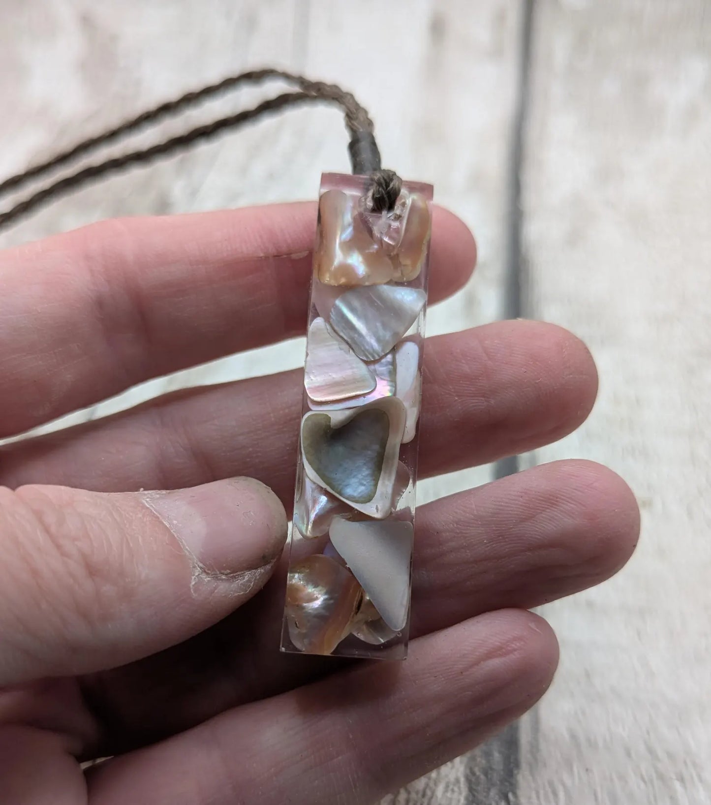 One New Zealand fresh water pink mussel shell in resin.