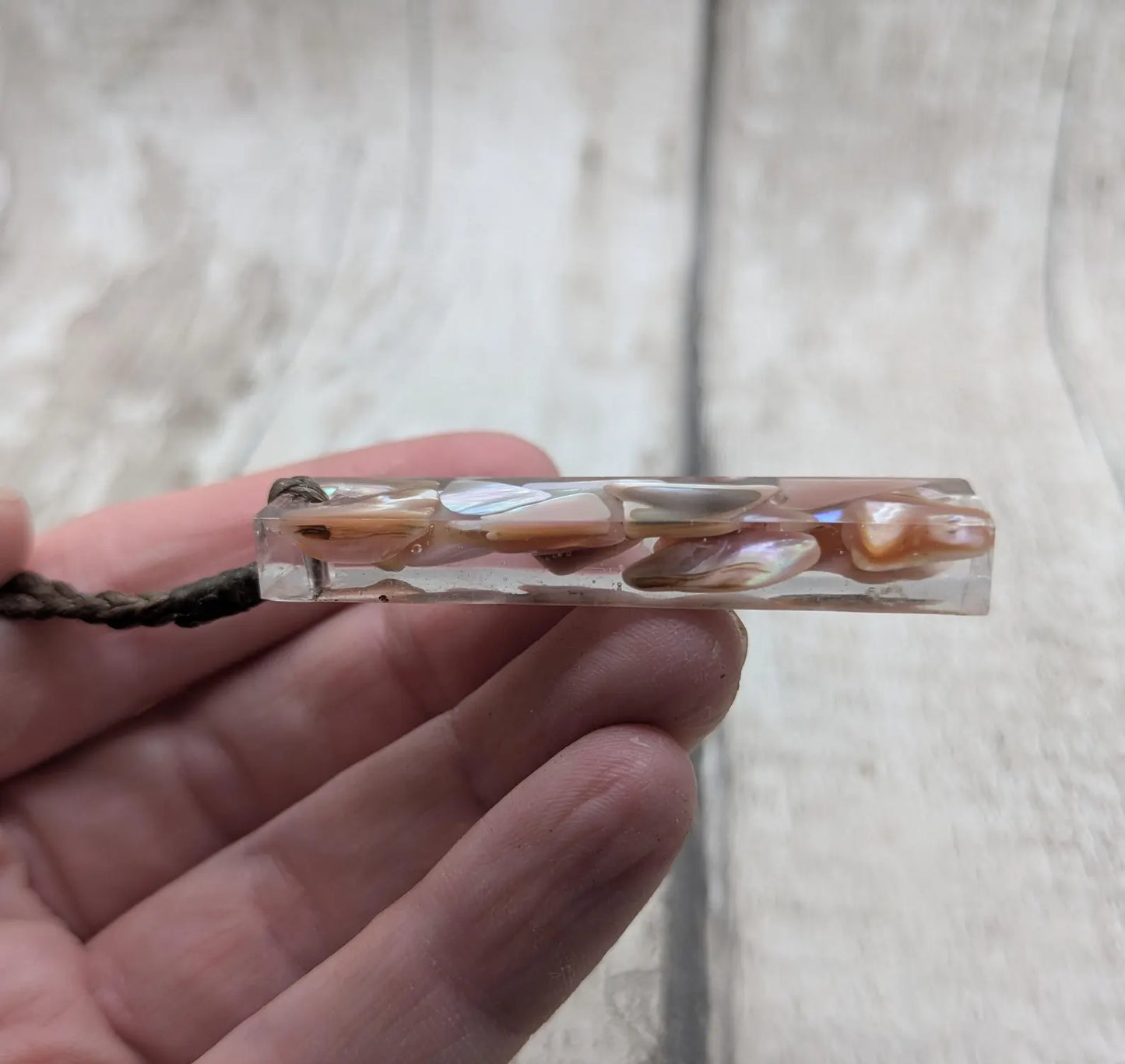 One New Zealand fresh water pink mussel shell in resin.