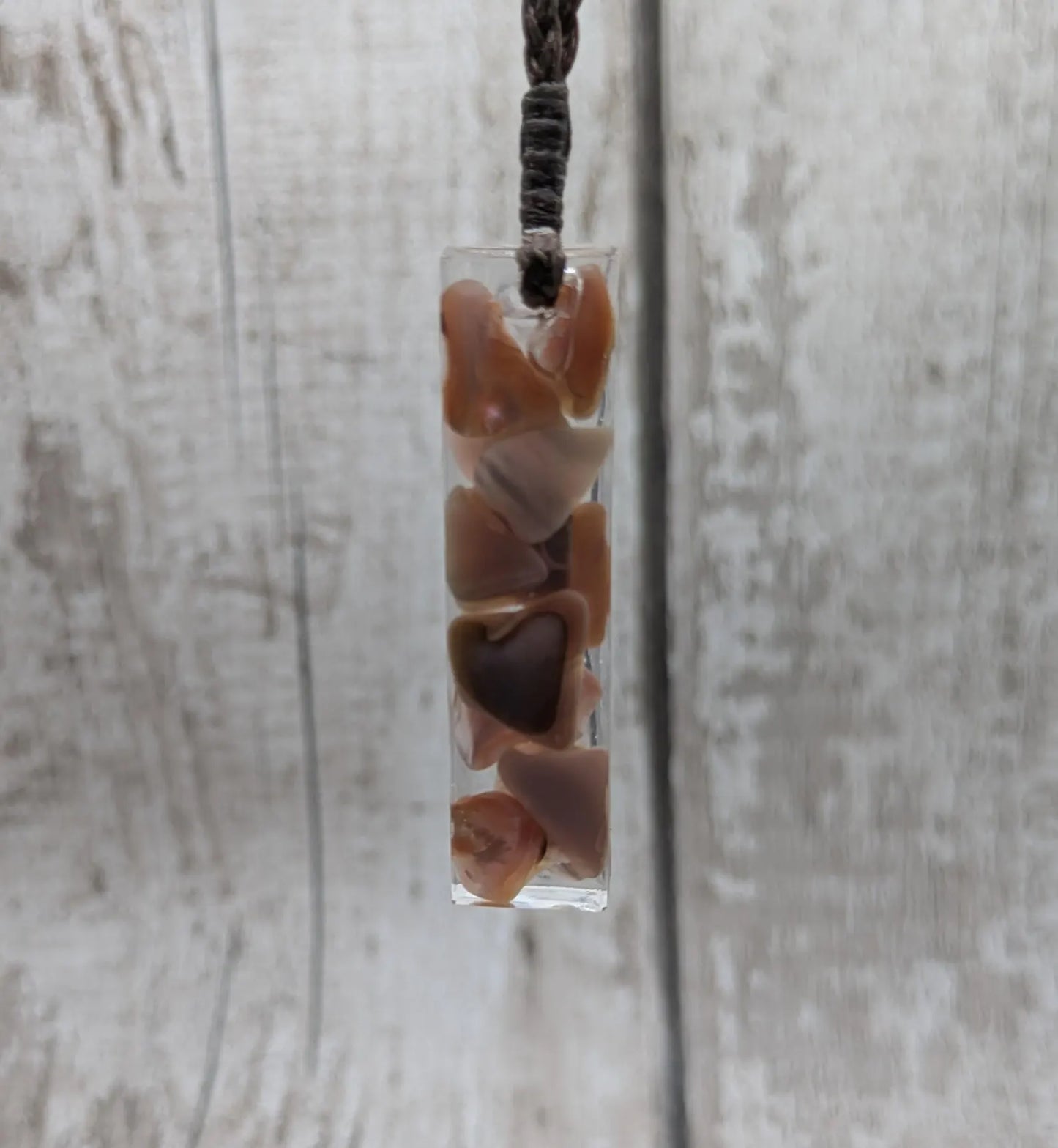 One New Zealand fresh water pink mussel shell in resin.