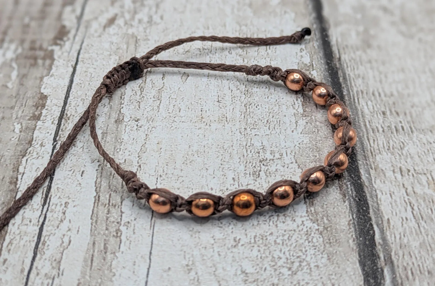 Copper beaded macramé woven adjustable bracelet.