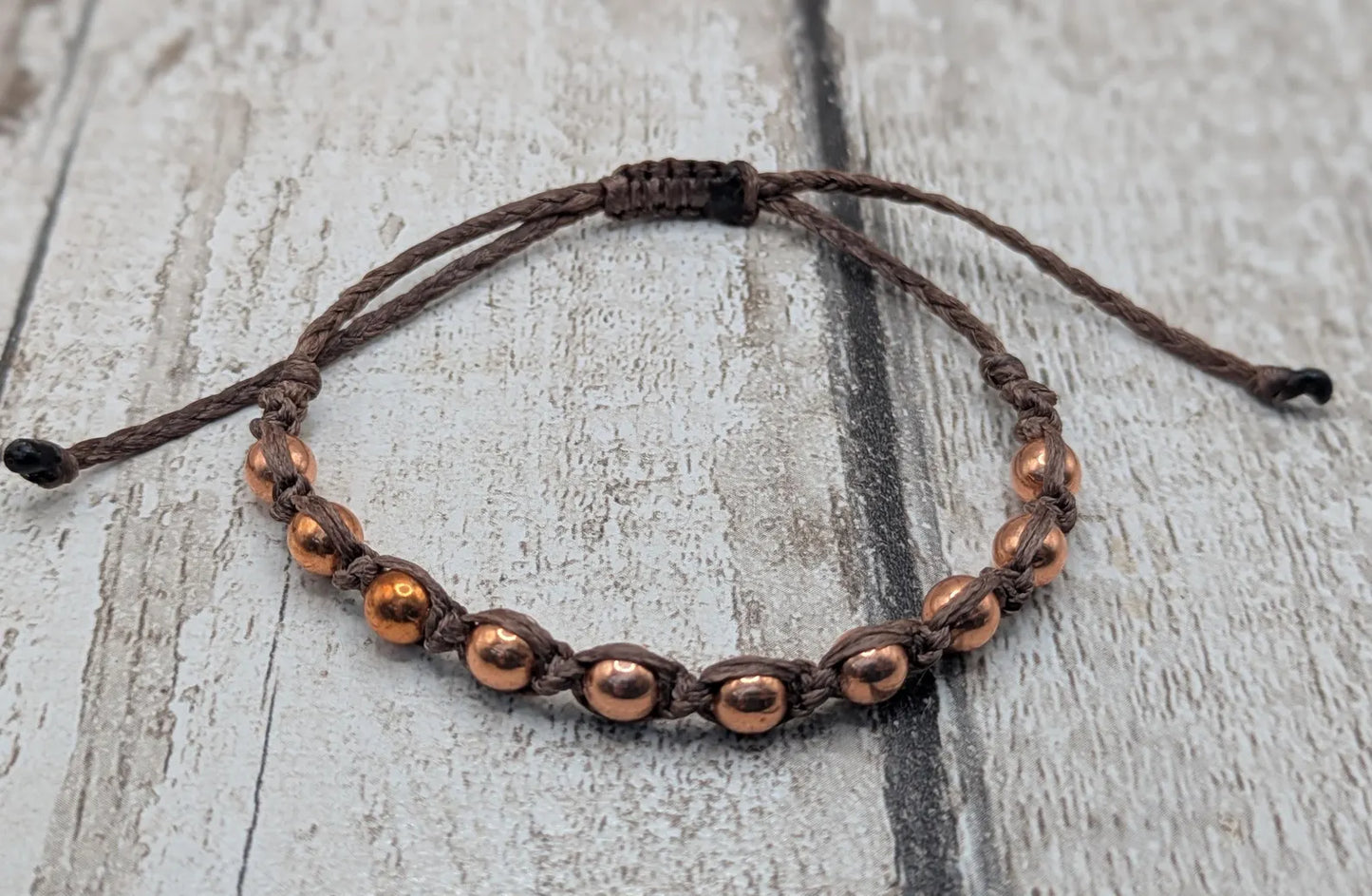 Copper beaded macramé woven adjustable bracelet.