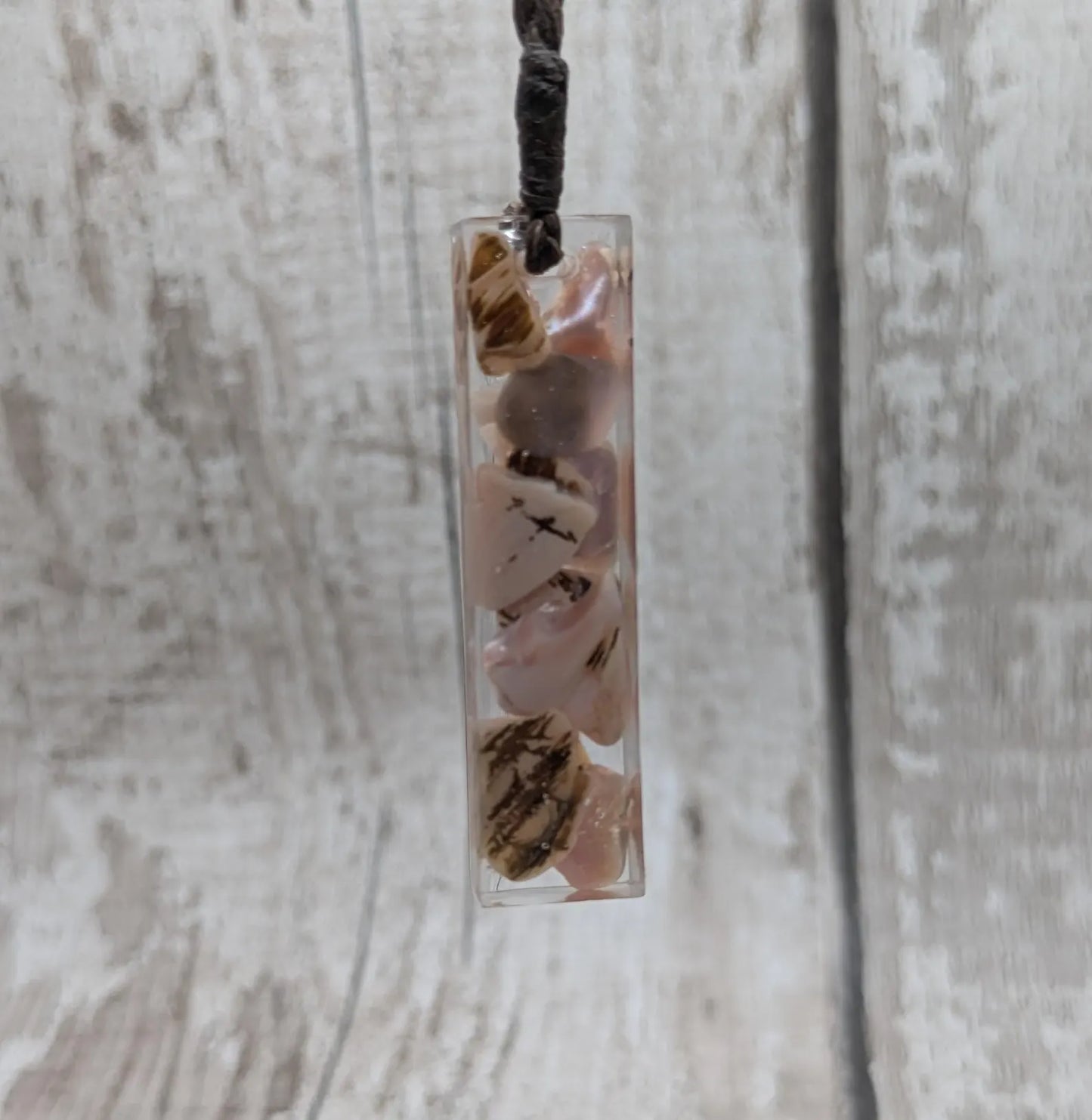 One New Zealand fresh water pink mussel shell in resin.