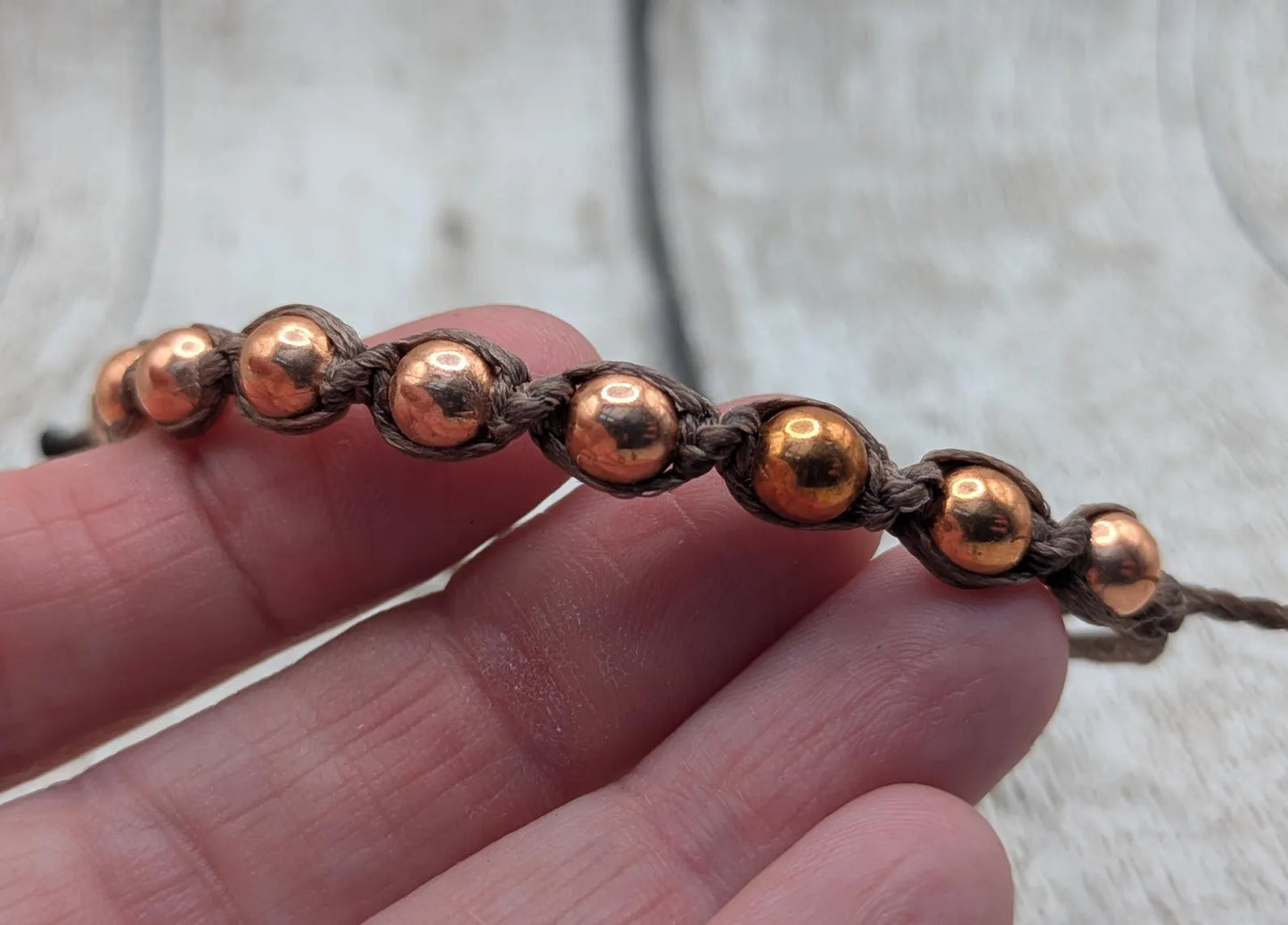 Copper beaded macramé woven adjustable bracelet.