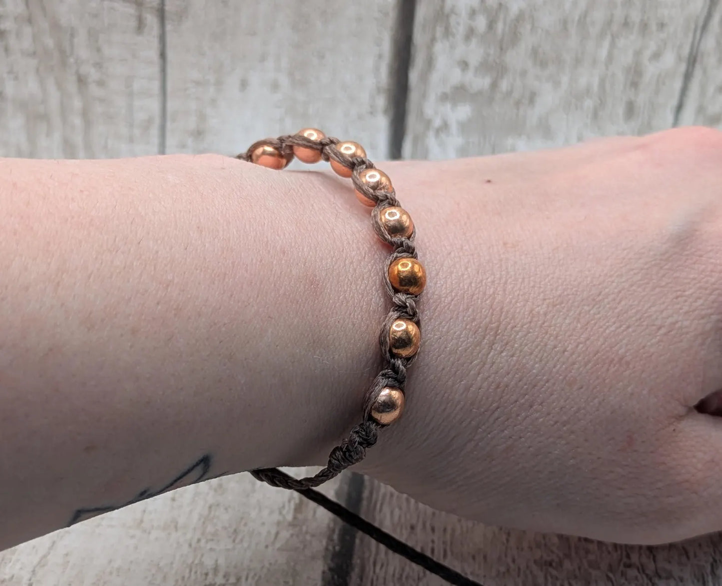 Copper beaded macramé woven adjustable bracelet.