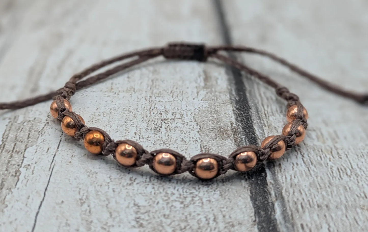 Copper beaded macramé woven adjustable bracelet.