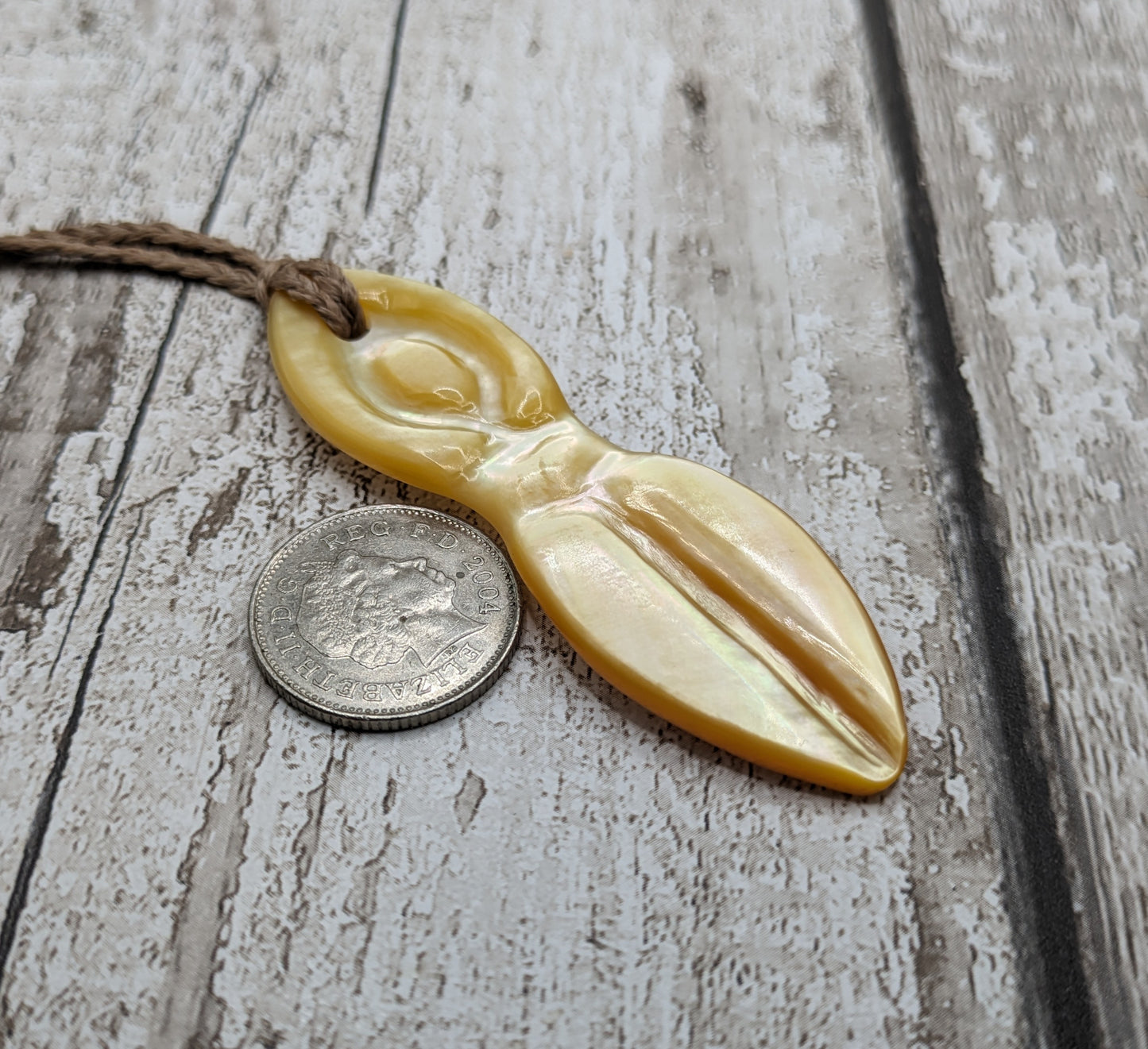 Mother of pearl shell goddess deity pendant.