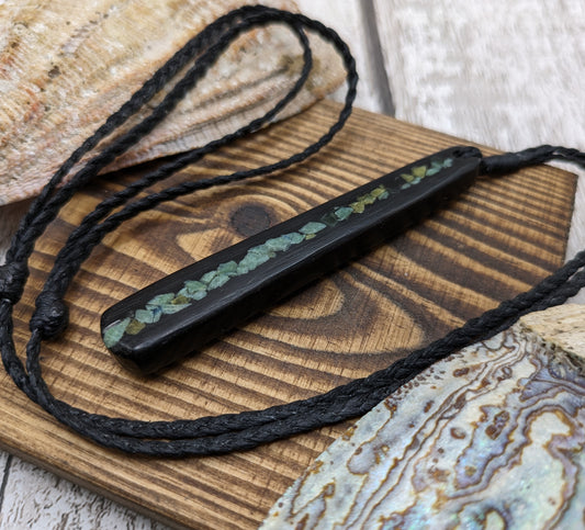 Fenland bog oak roimata with pounamu greenstone pendant.