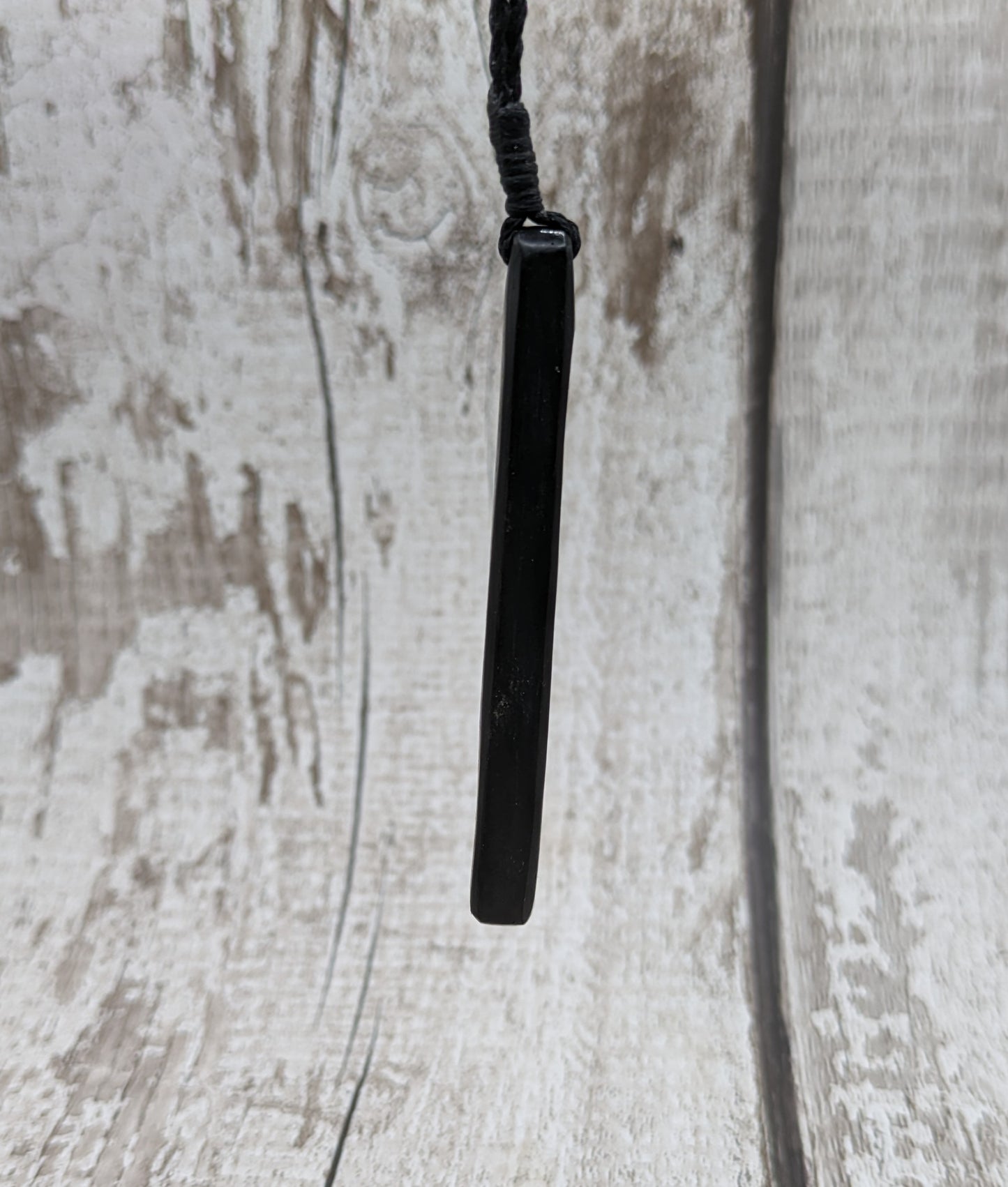 Fenland bog oak roimata with pounamu greenstone pendant.