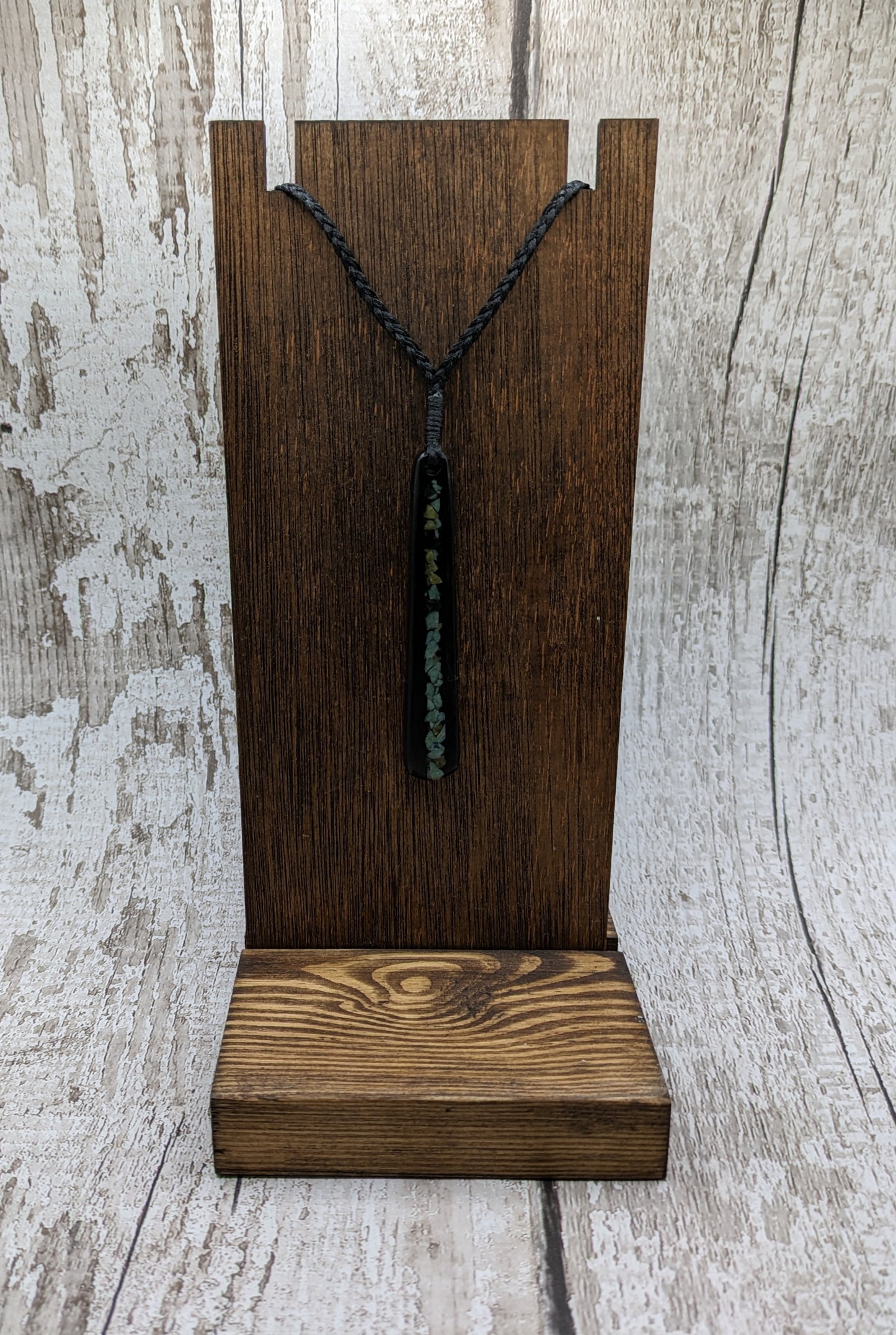 Fenland bog oak roimata with pounamu greenstone pendant.