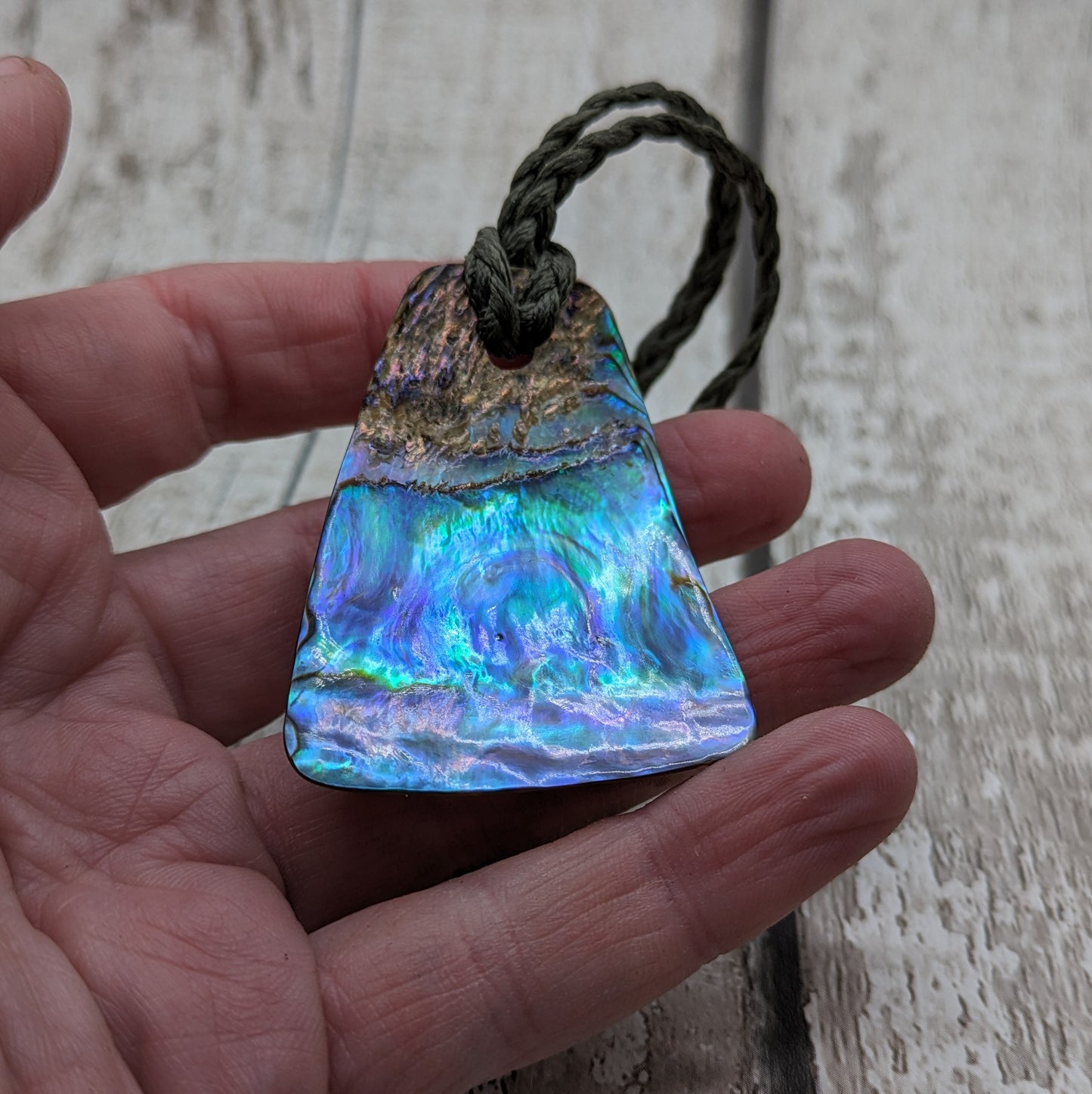 New Zealand rainbow pāua shell pendant.