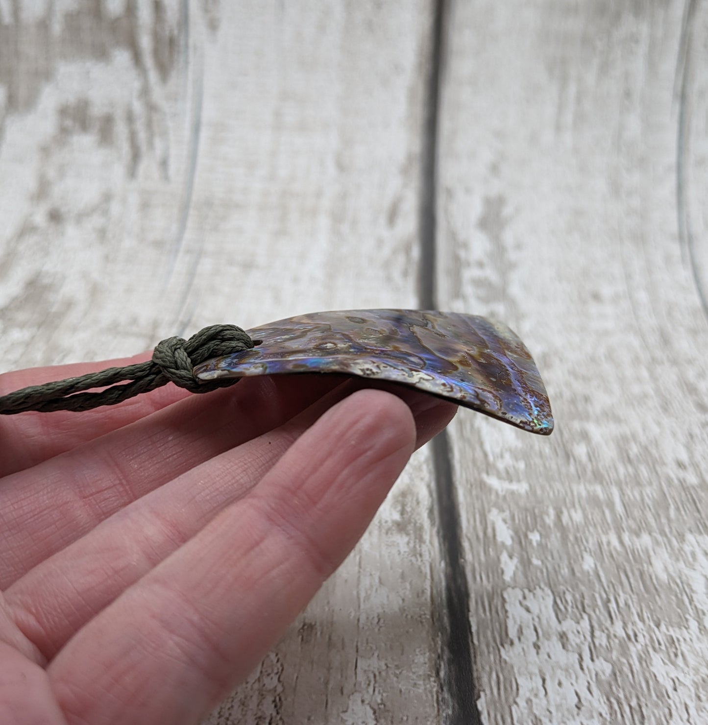 New Zealand rainbow pāua shell pendant.