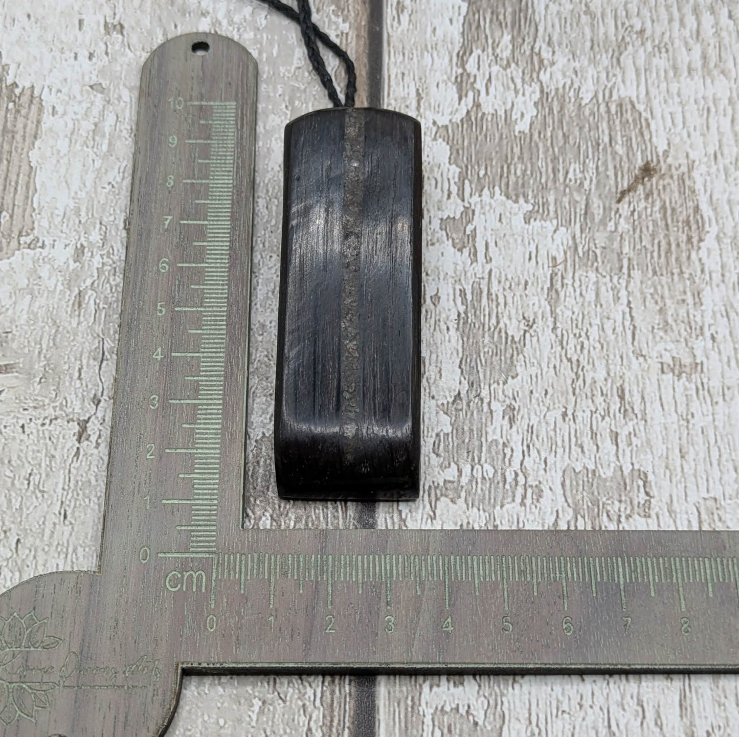 Fenland bog oak with mammoth tooth inlay, Toki adze style pendant.