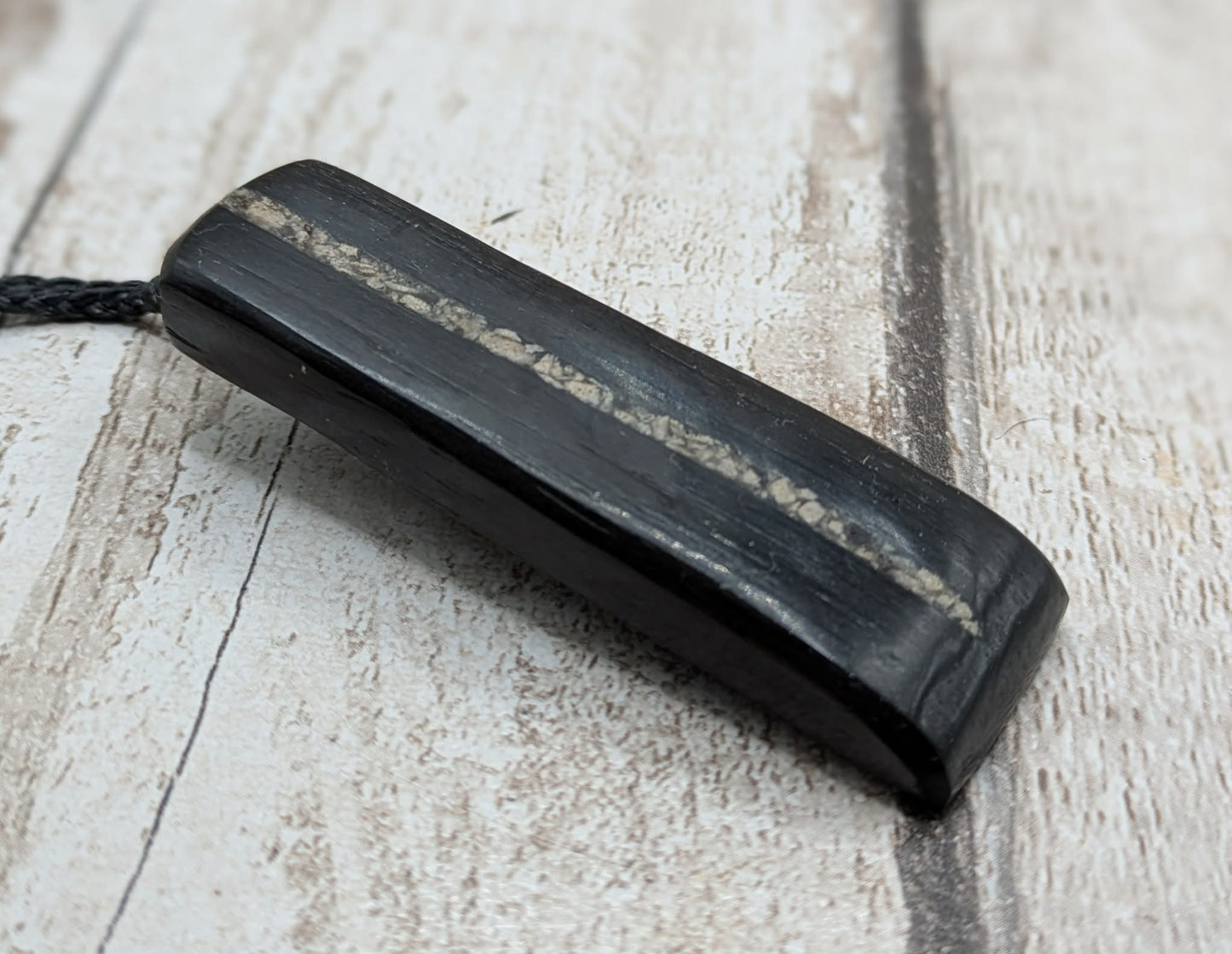Fenland bog oak pendant with Avebury Sarsen inlay.