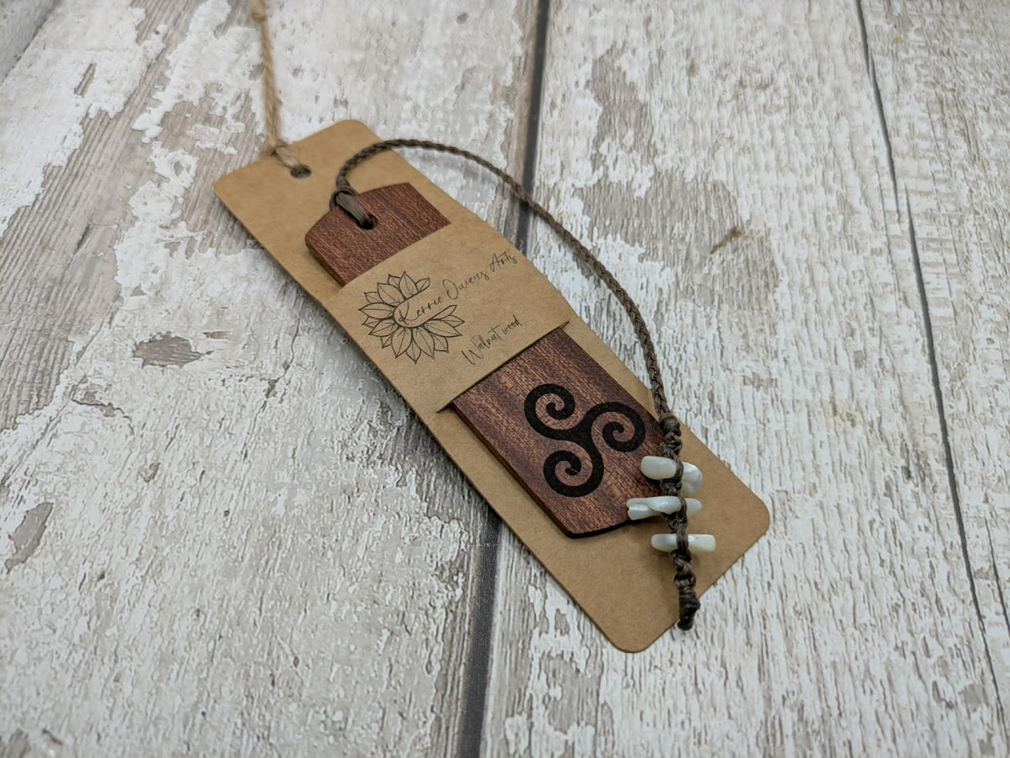 Walnut wood hand made bookmark with triskele laser print.
