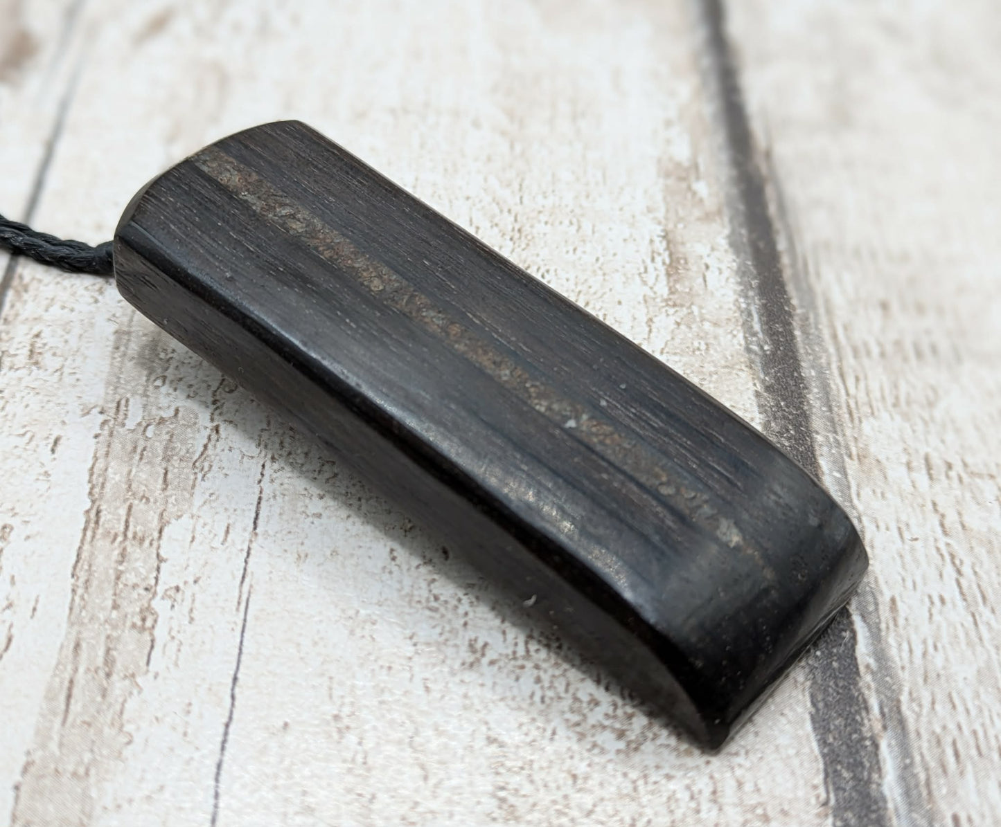 Fenland bog oak with mammoth tooth inlay, Toki adze style pendant.