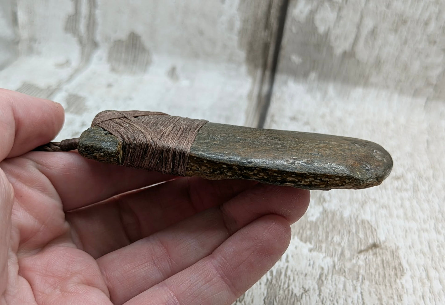 Fossilised whale bone hei toki adze with natural texture.