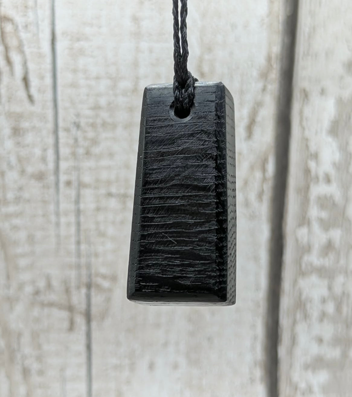 Fenland bog oak rectangular pendant with mammoth tooth inlay.