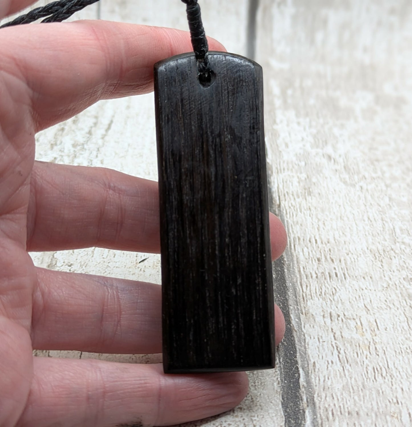 Fenland bog oak with mammoth tooth inlay, Toki adze style pendant.