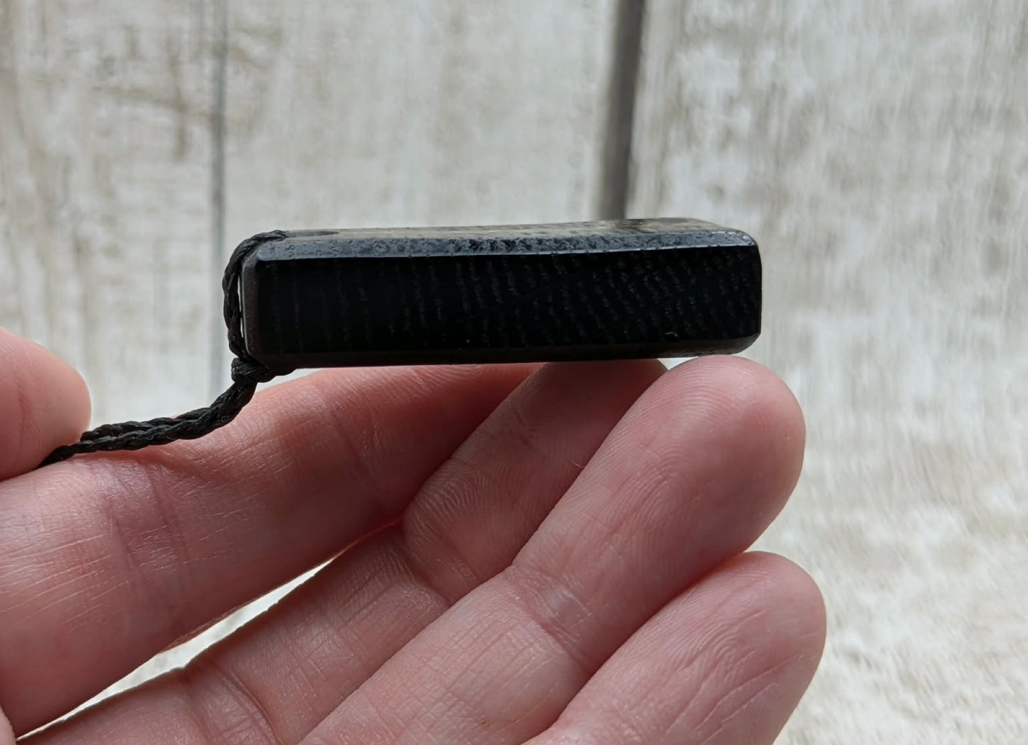 Fenland bog oak rectangular pendant with mammoth tooth inlay.