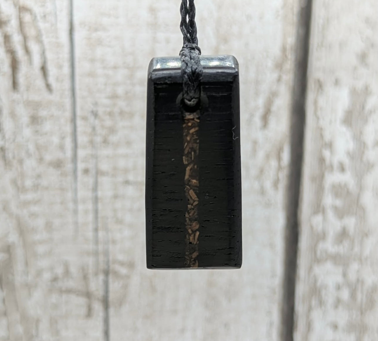 Fenland bog oak rectangular pendant with mammoth tooth inlay.
