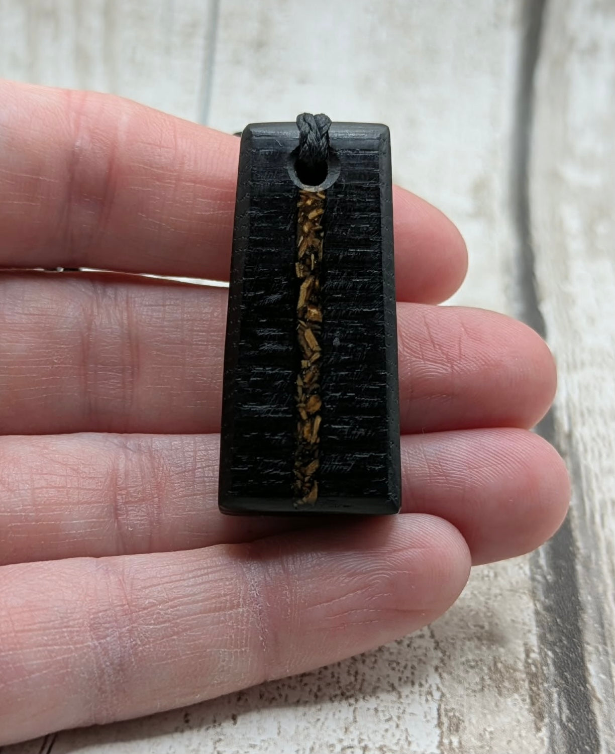 Fenland bog oak rectangular pendant with mammoth tooth inlay.