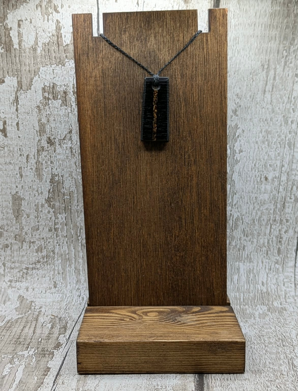 Fenland bog oak rectangular pendant with mammoth tooth inlay.