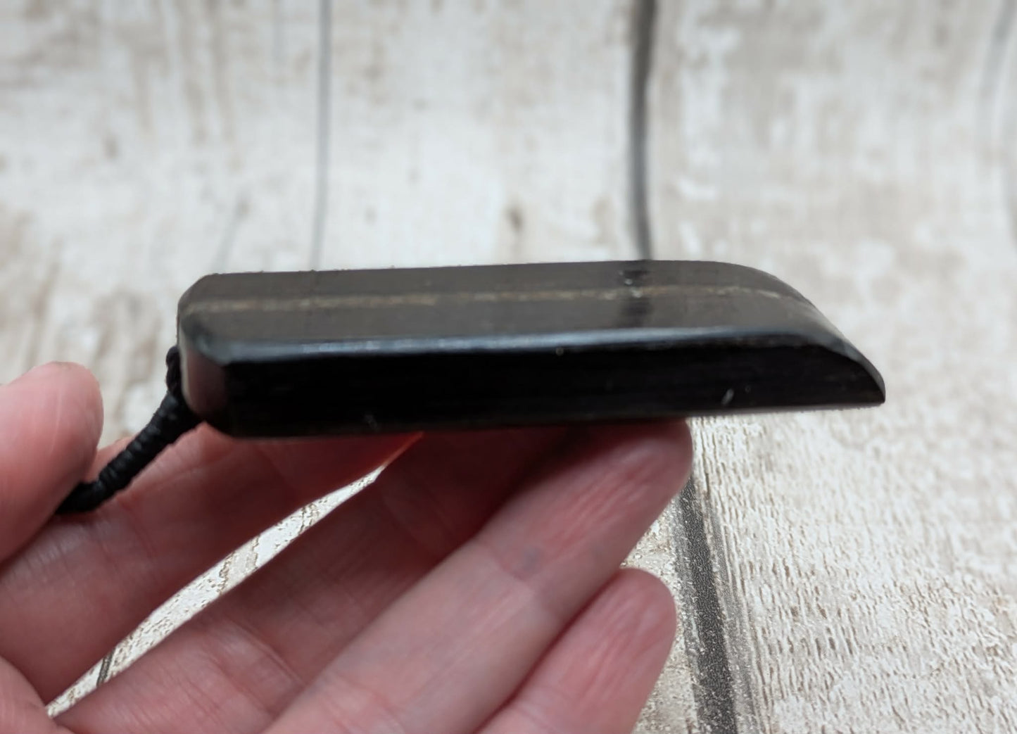 Fenland bog oak with mammoth tooth inlay, Toki adze style pendant.