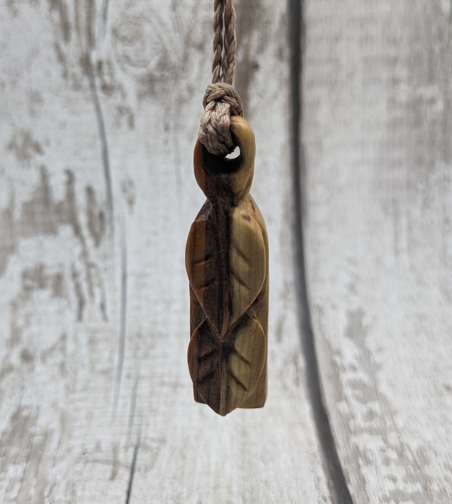 yew wood woodland leaves carved pendant.