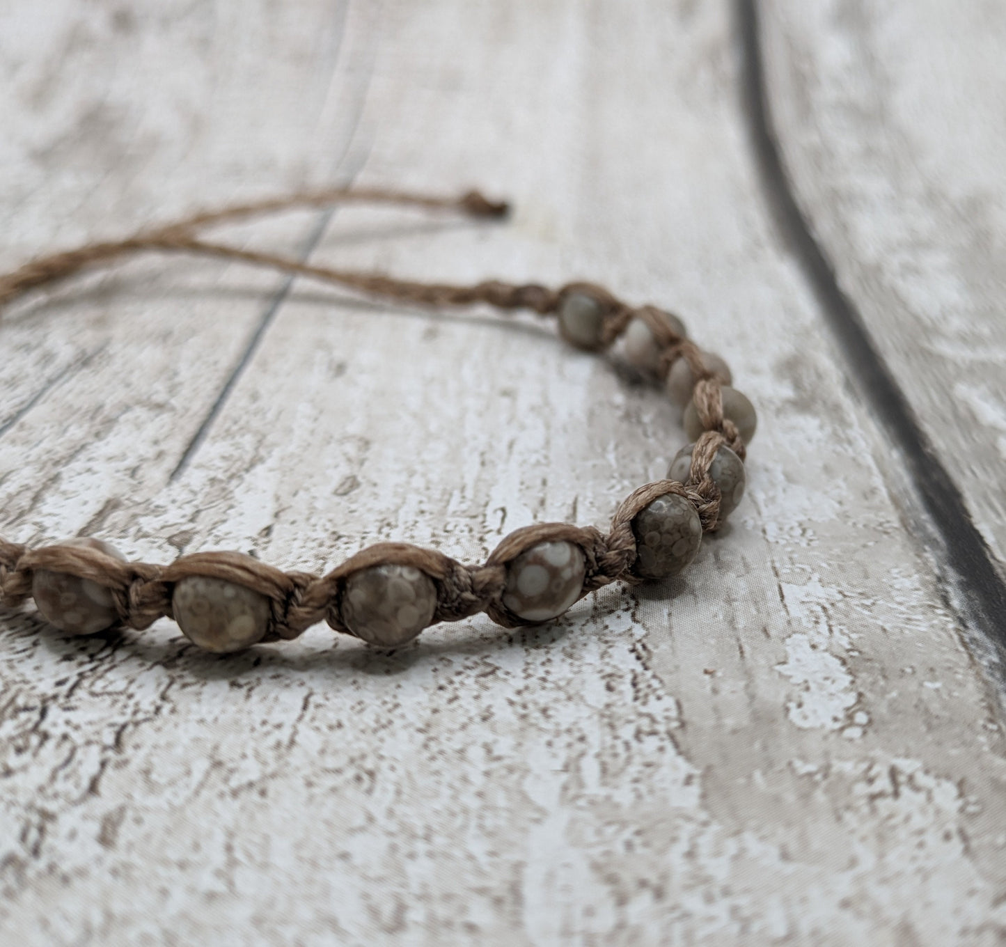 crianoid and fossilized coral beaded macrame bracelet.