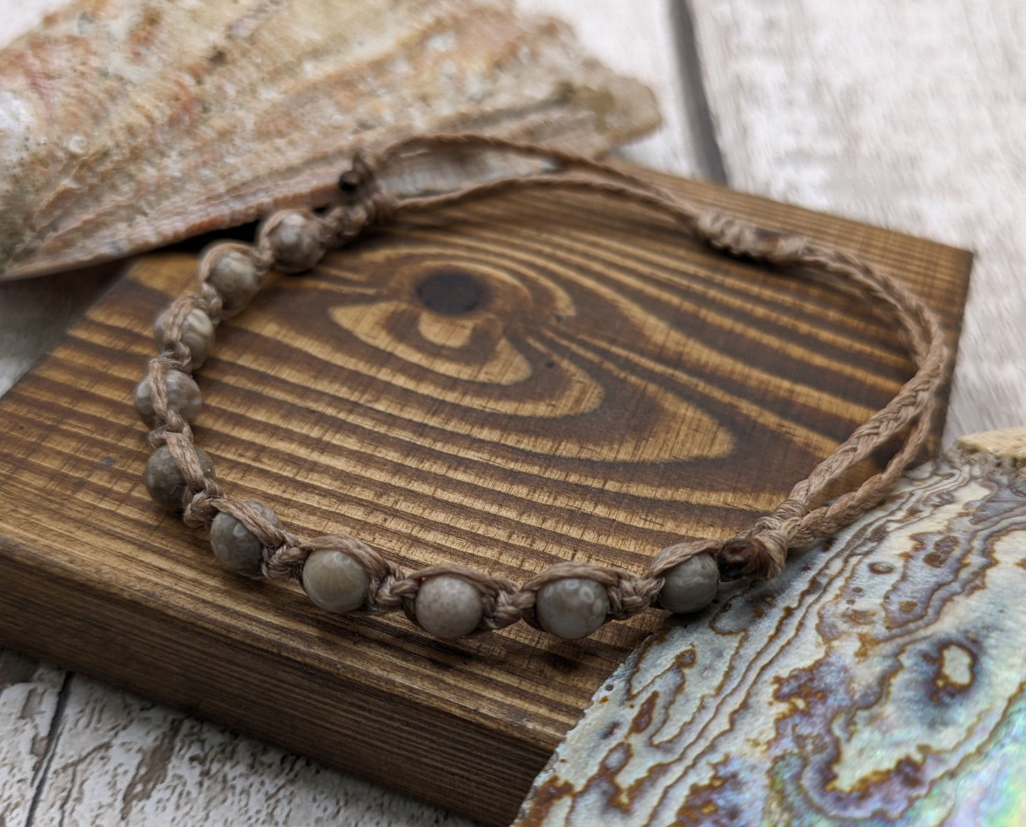 crianoid and fossilized coral beaded macrame bracelet.