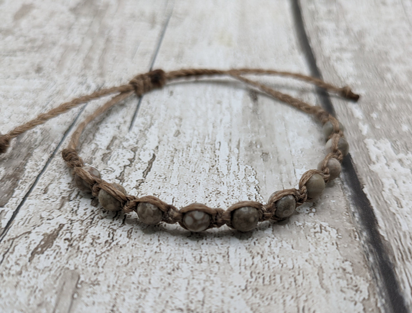 crianoid and fossilized coral beaded macrame bracelet.