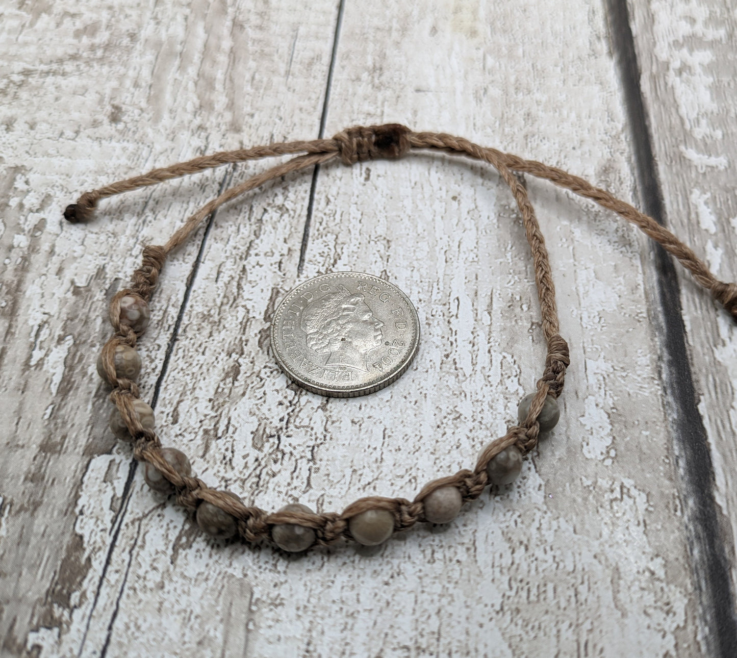 crianoid and fossilized coral beaded macrame bracelet.