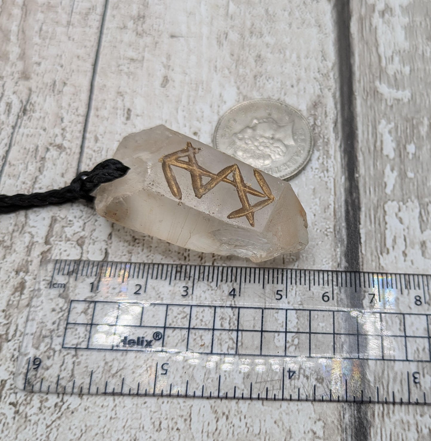 Clear quartz point bind rune empowerment pendant.