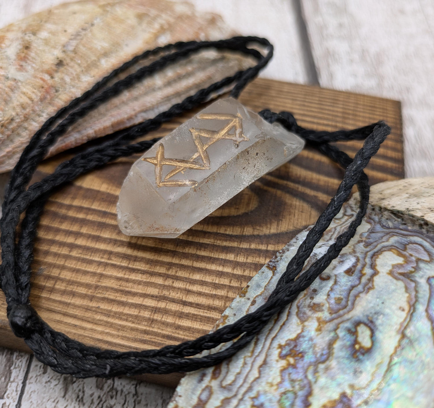 Clear quartz point bind rune empowerment pendant.