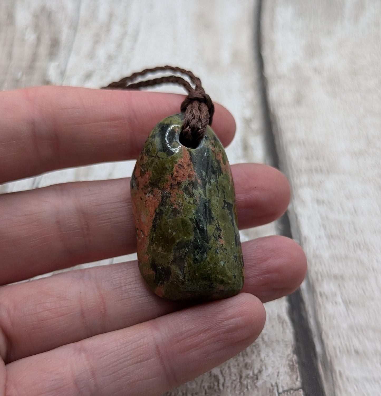 unakite tumbled stone pendant.