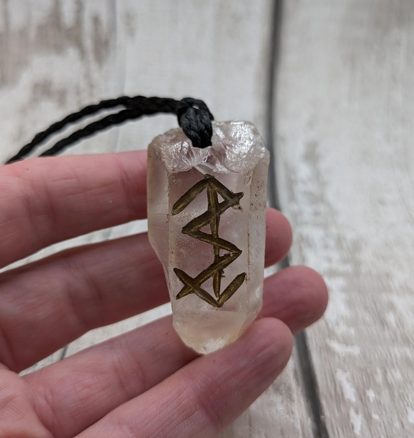 Clear quartz point bind rune empowerment pendant.